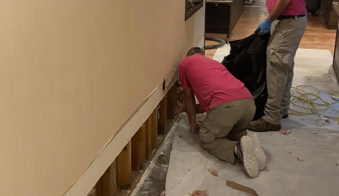 man fixing wall stucture