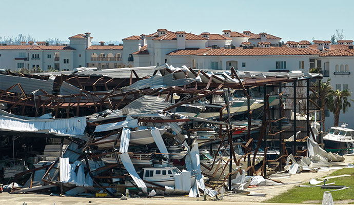 Houses and a street covered in debris after a severe storm.